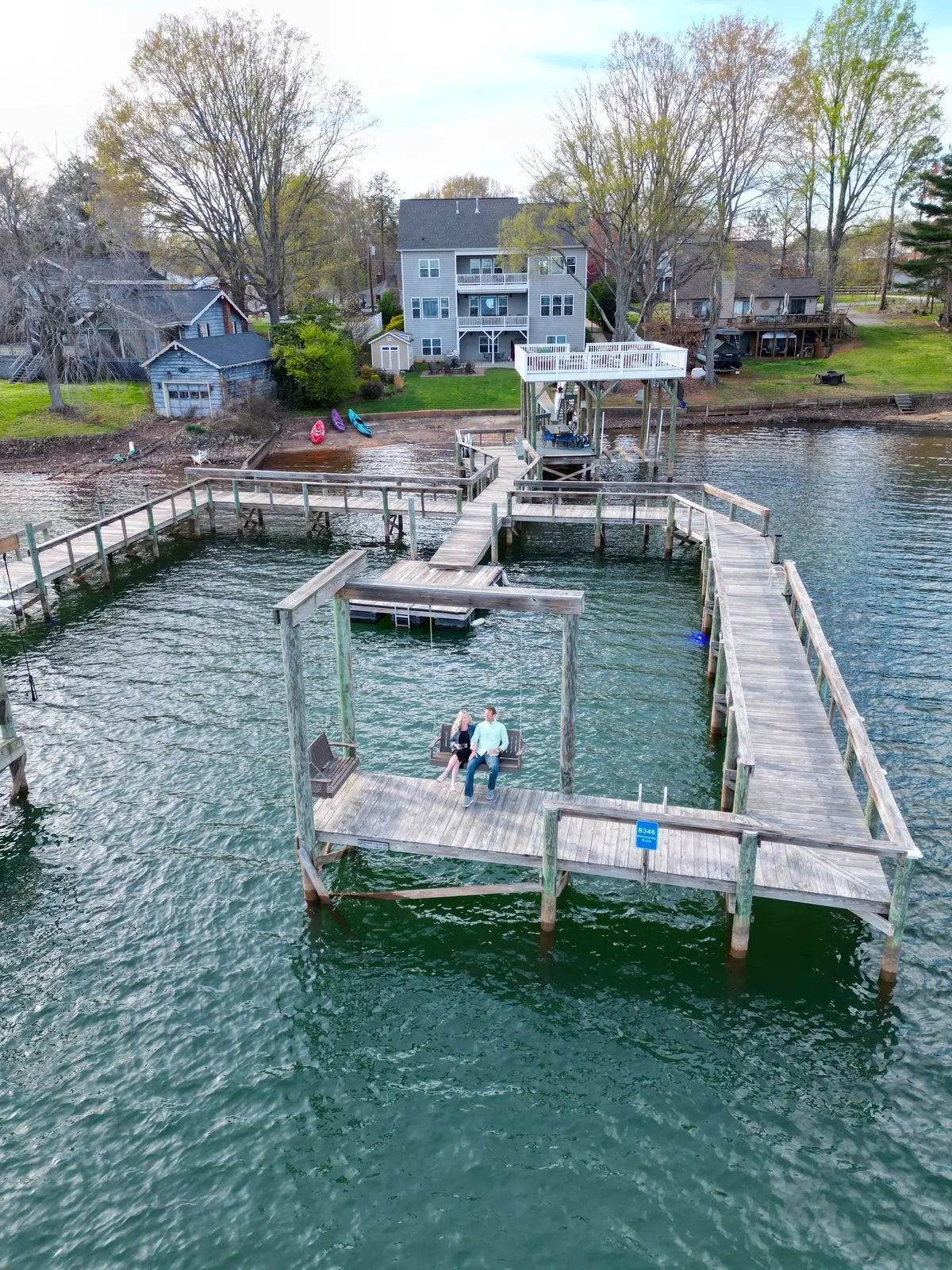 Couple on the dock swing — aerial view