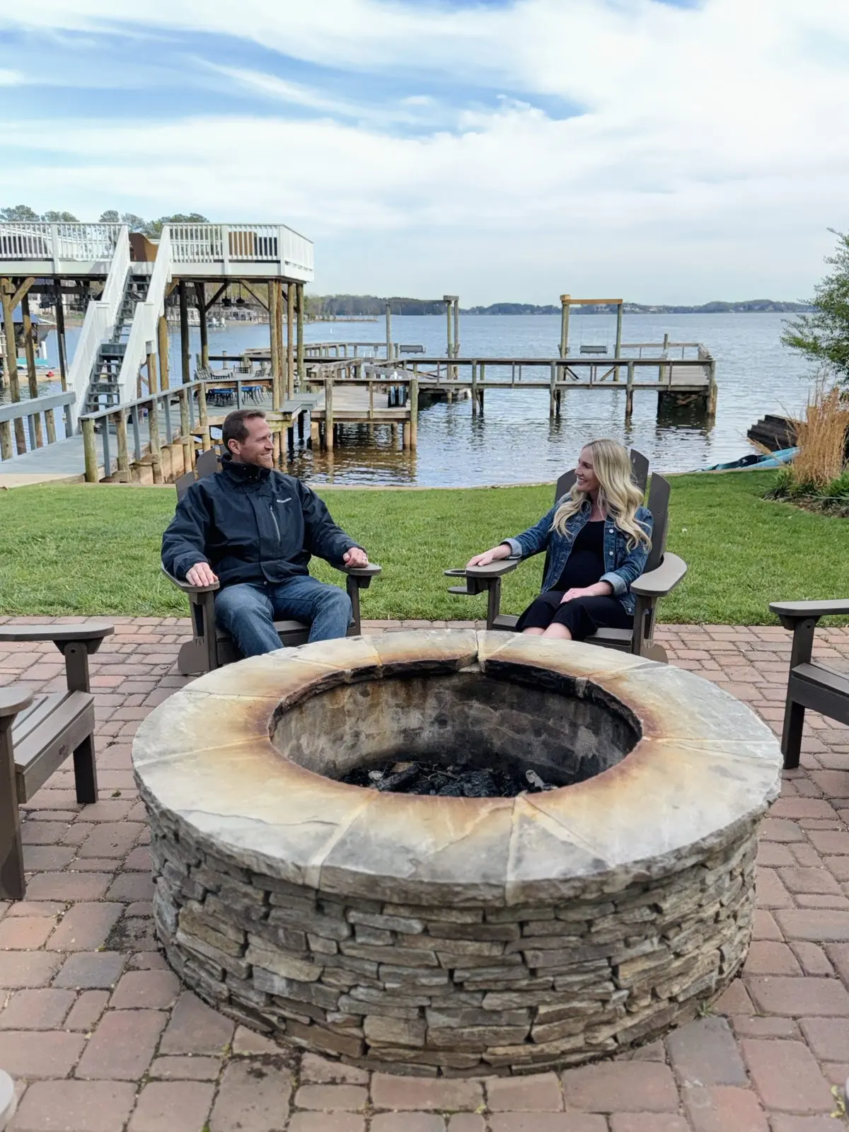 Couple relaxing by the fire pit overlooking Lake Norman